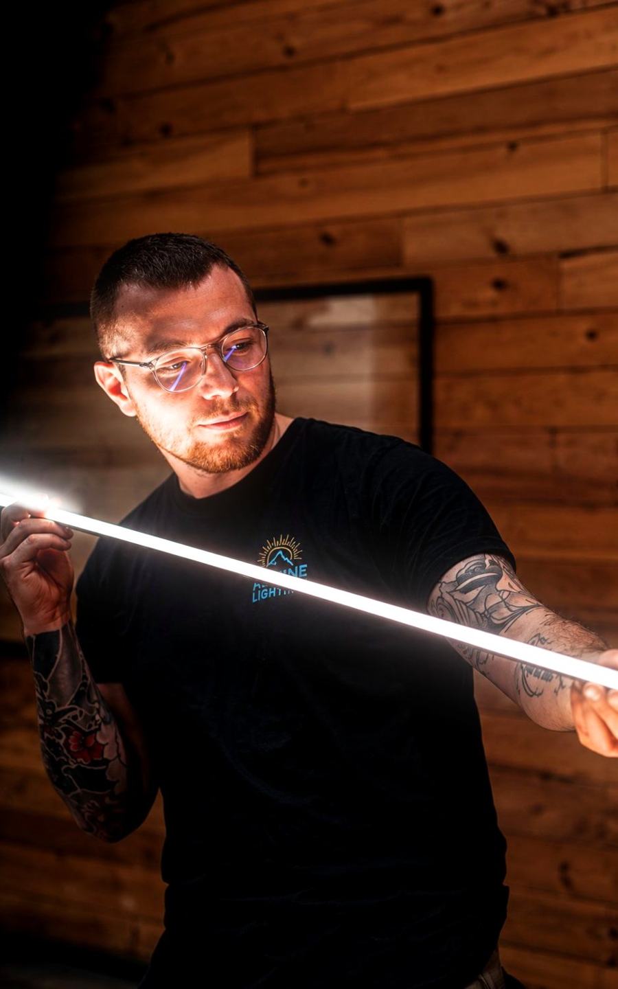 Jérémy Fonteneau-Gasperoni façonnant un tube LED dans l'atelier Alpine Lighting